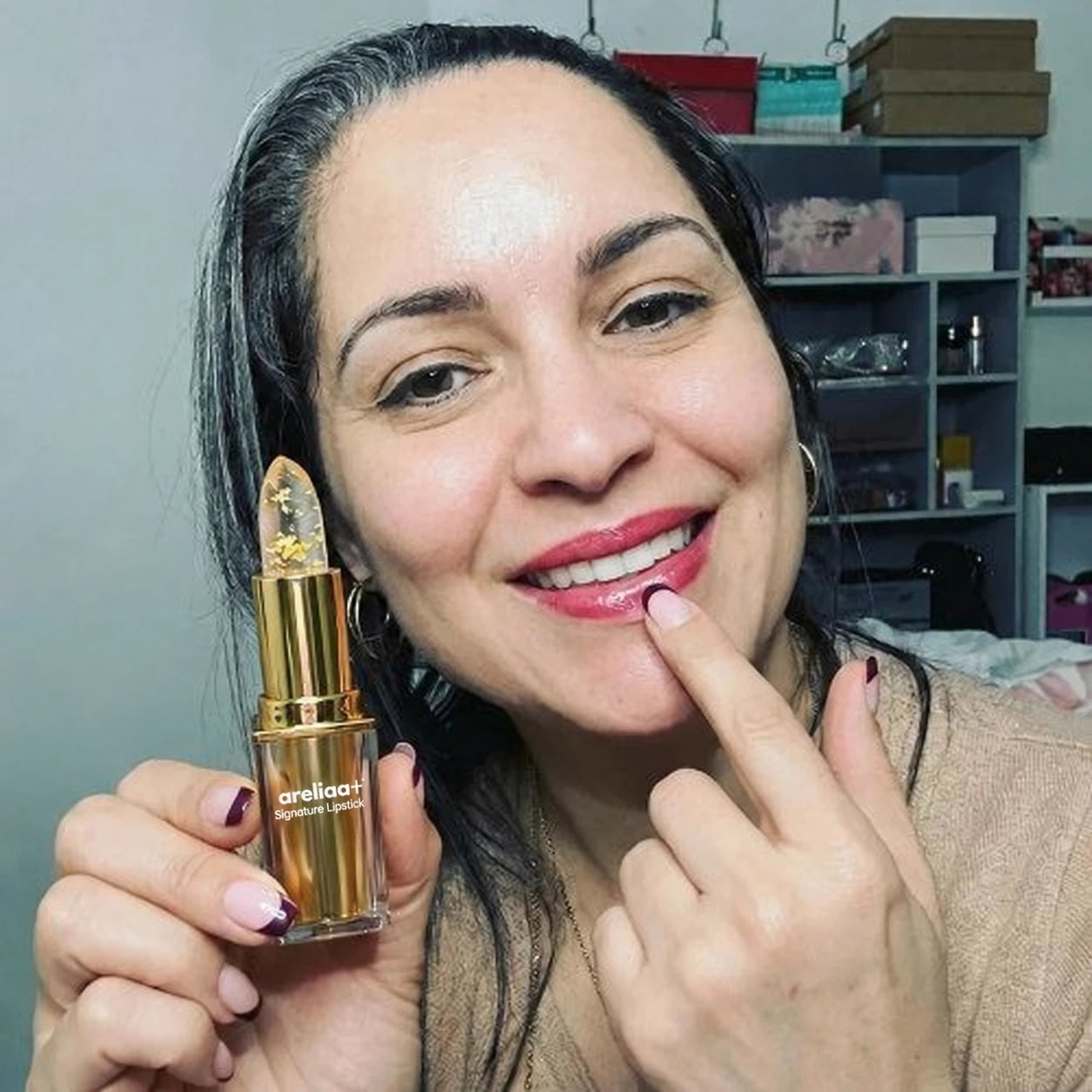 Woman holding areliaa+ Signature Lipstick
