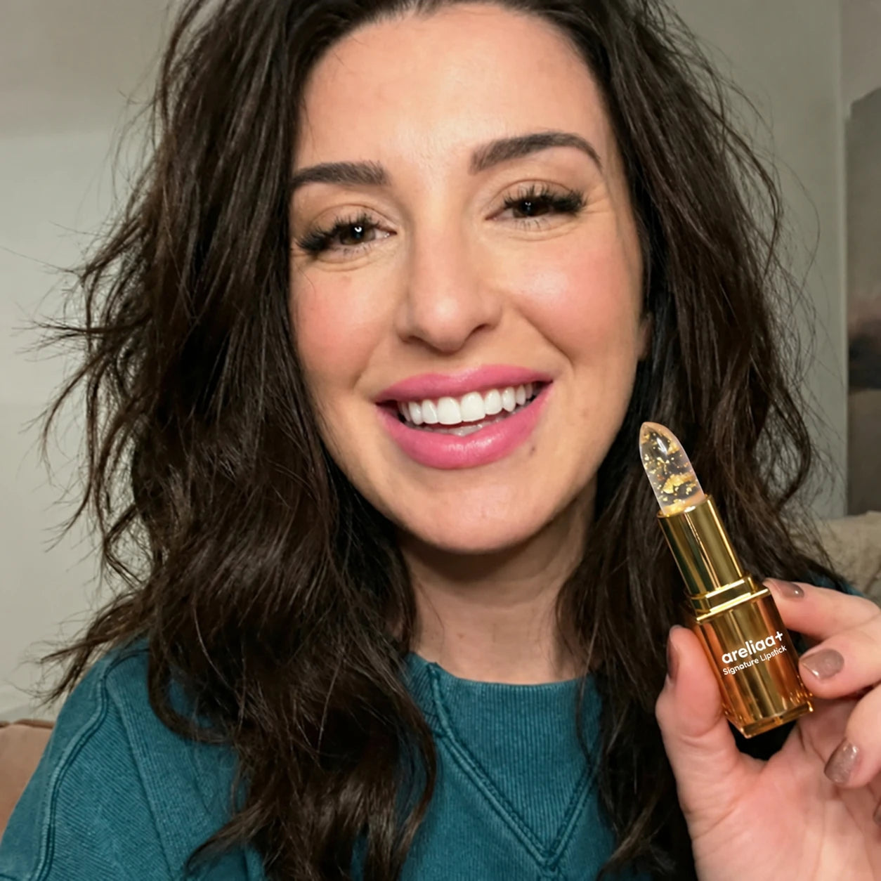 Woman holding areliaa+ Signature Lipstick