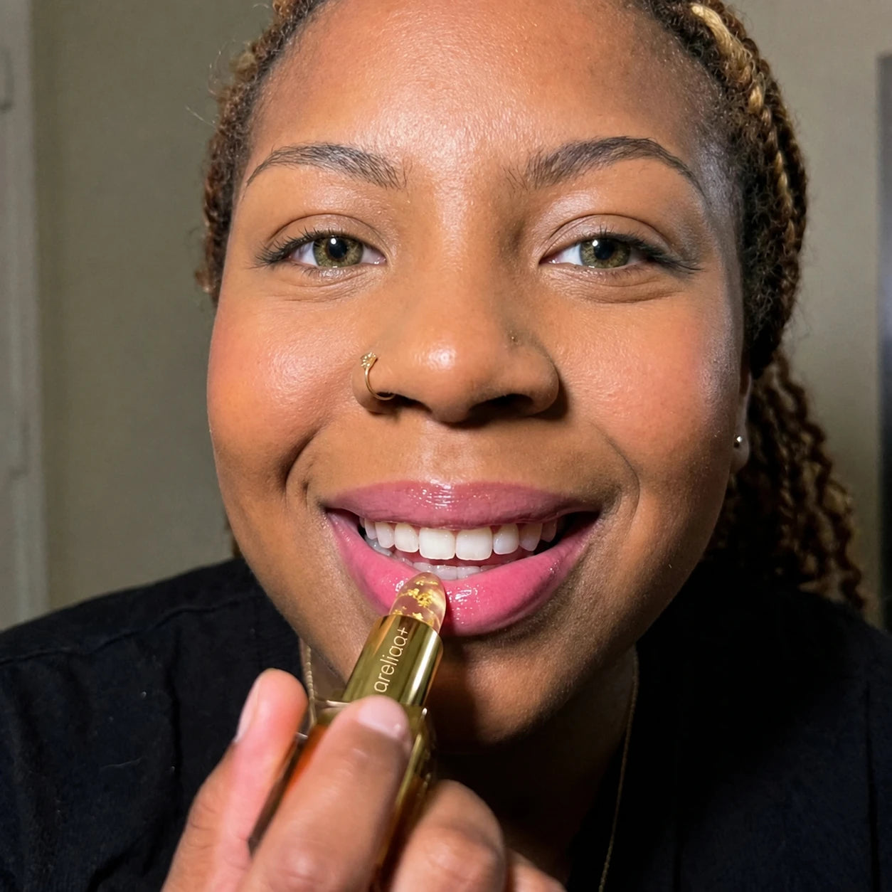 Woman holding areliaa+ Signature Lipstick