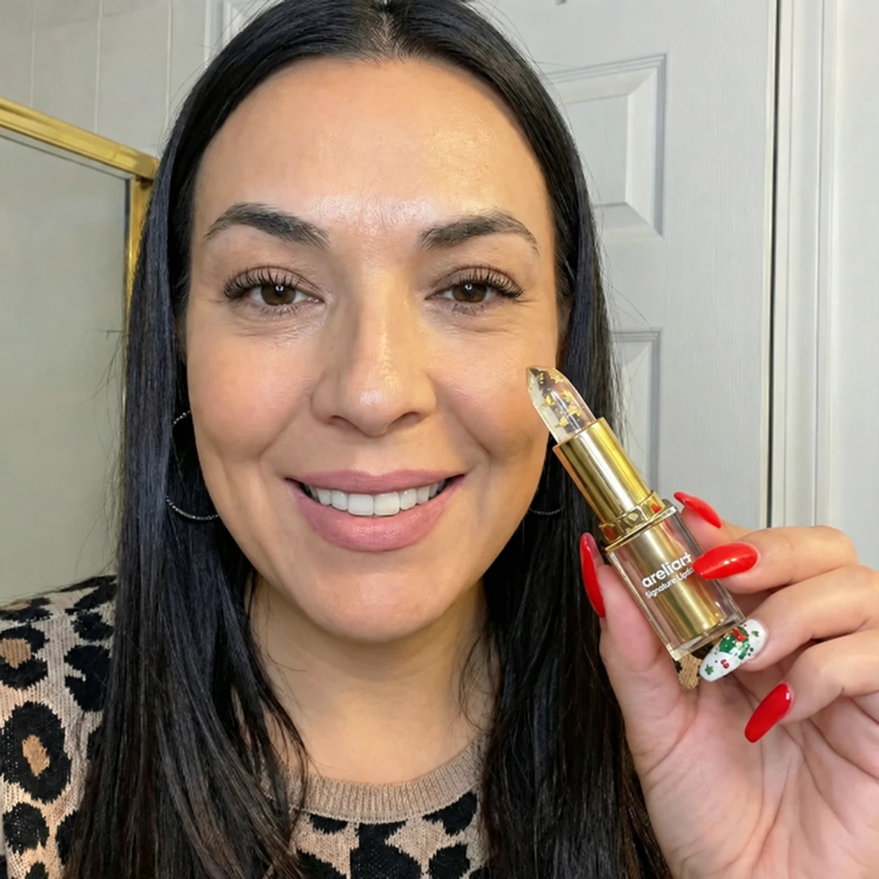 Woman holding areliaa+ Signature Lipstick